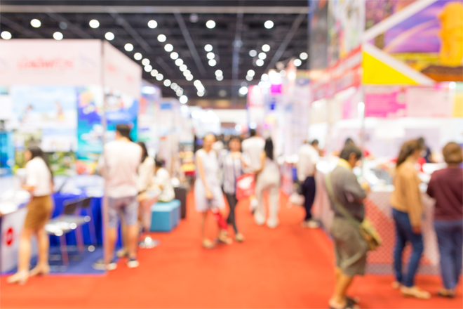 A blurred image of a tradeshow floor.