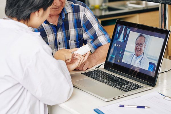 Two patients and a physician taking part in a virtual telehealth appointment.