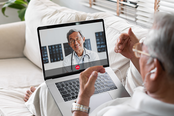 A patient and a physician taking part in a virtual telehealth appointment.
