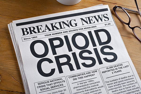 Opioid Crisis Newspaper Headline. Newspaper Is On A Desk